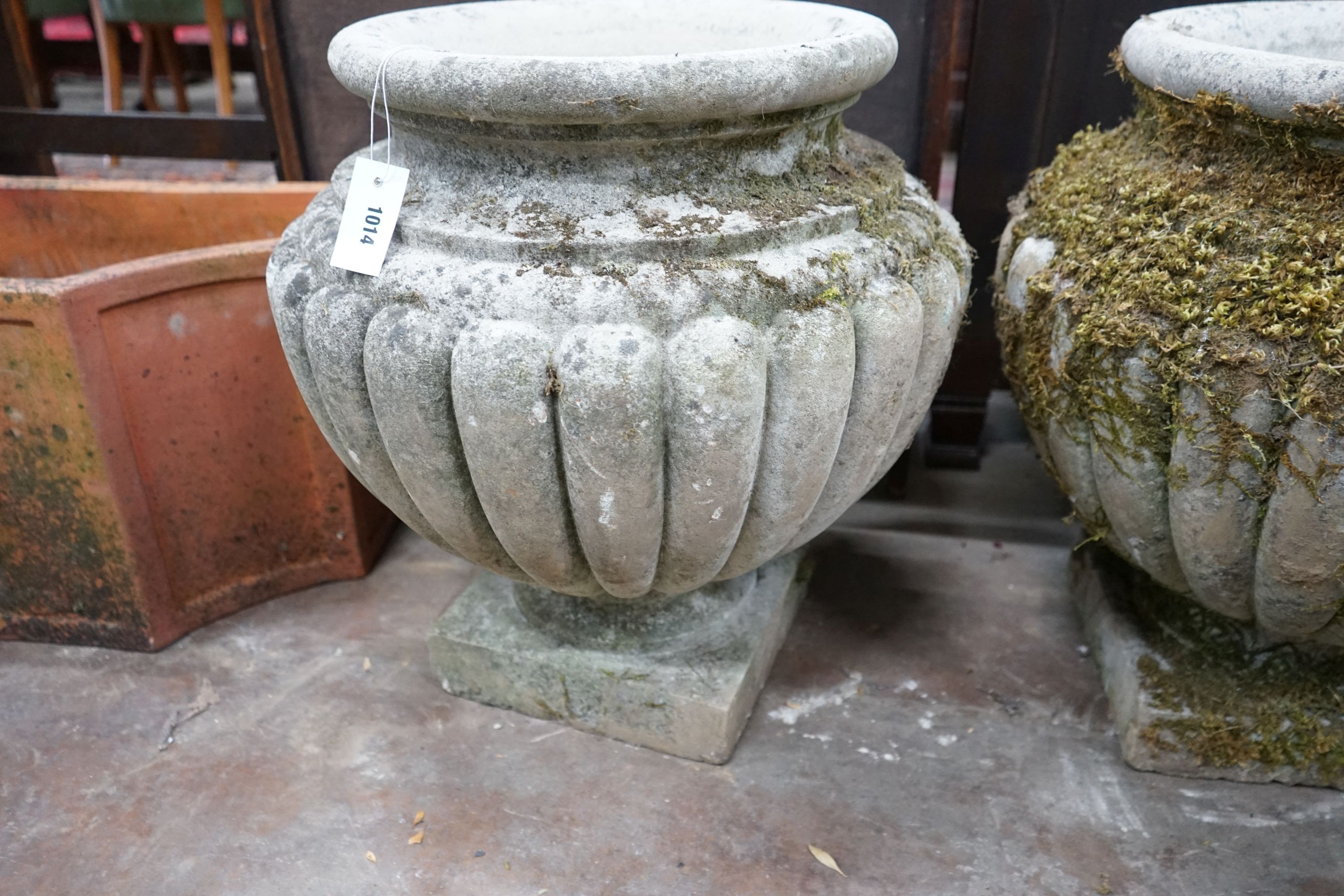 A pair of circular reconstituted stone garden planters, diameter 54cm, height 56cm